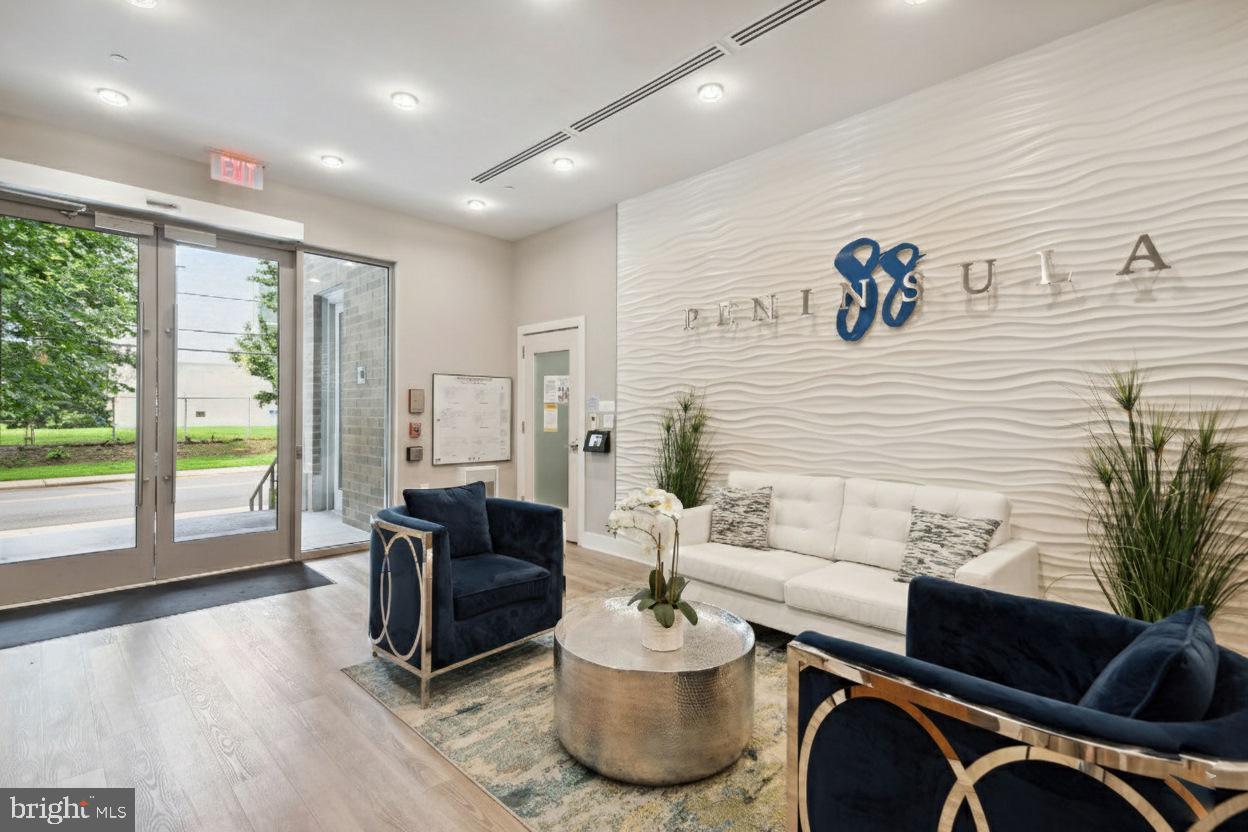 88 V Street Southwest, Unit 313 Washington, DC 20024 - Photo 21 of 38 a living room with furniture and large windows