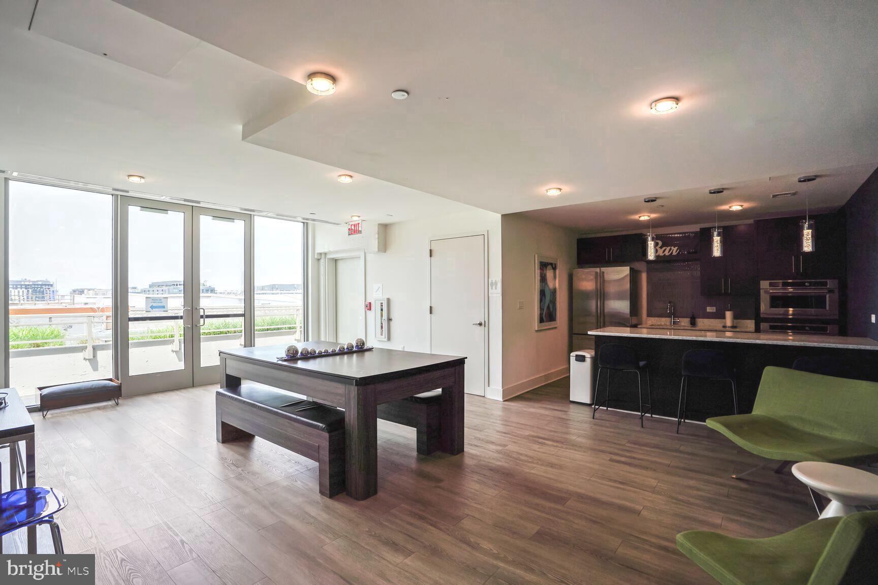 88 V Street Southwest, Unit 313 Washington, DC 20024 - Photo 30 of 38 a living room with furniture a large window with kitchen view