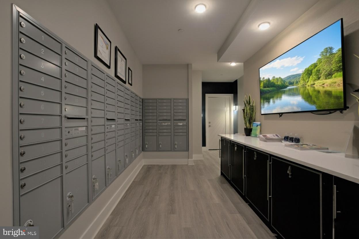 88 V Street Southwest, Unit 313 Washington, DC 20024 - Photo 32 of 38 a bathroom with a sink a large mirror and a shower
