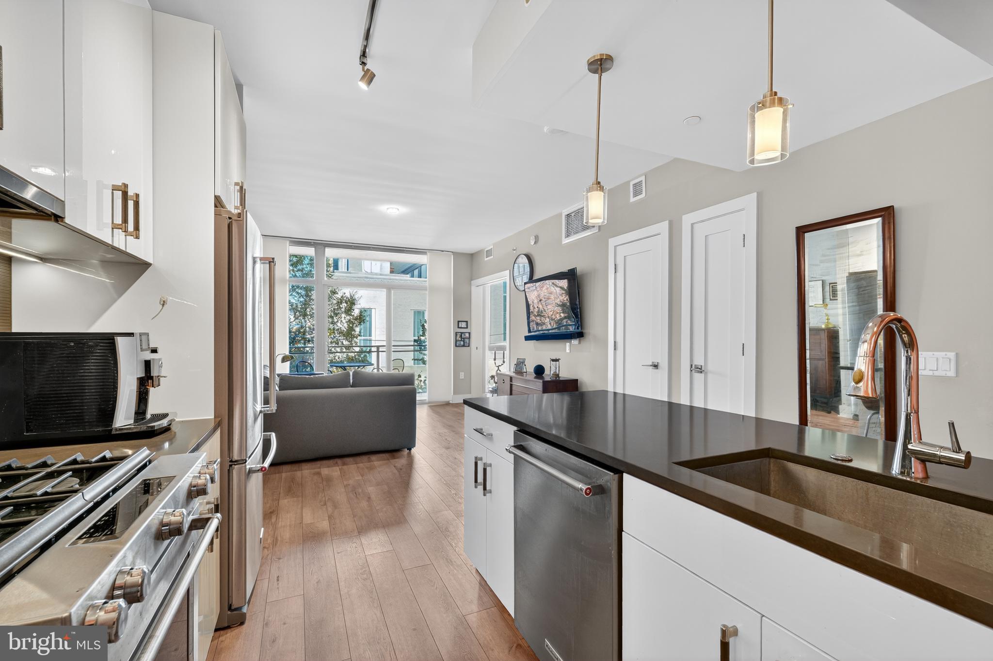 88 V Street Southwest, Unit 313 Washington, DC 20024 - Photo 4 of 38 a kitchen with stainless steel appliances a sink stove and microwave