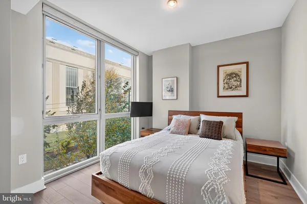 a bedroom with a large bed and a large window