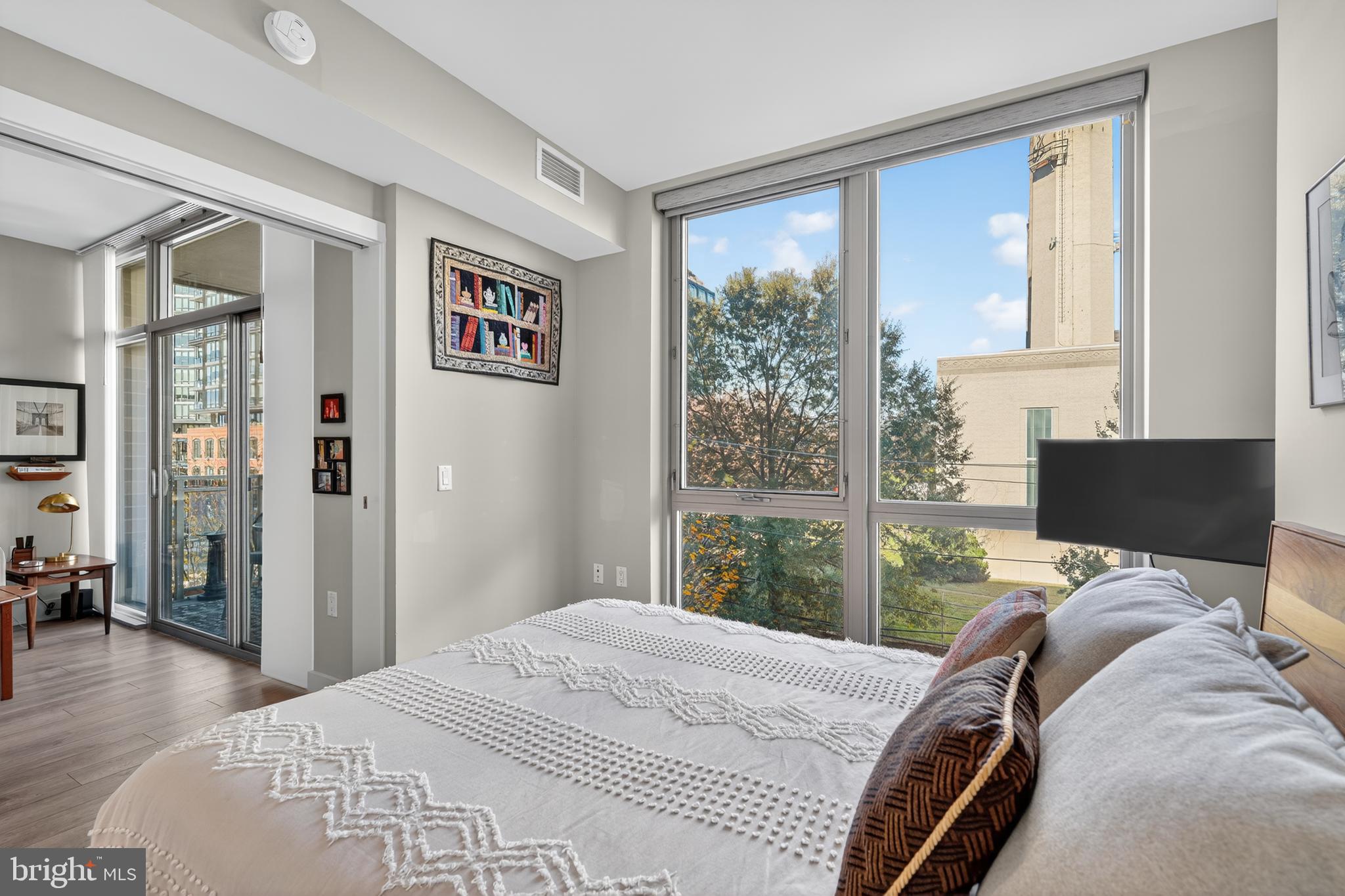 88 V Street Southwest, Unit 313 Washington, DC 20024 - Photo 9 of 38 a bedroom with a bed and wooden floor