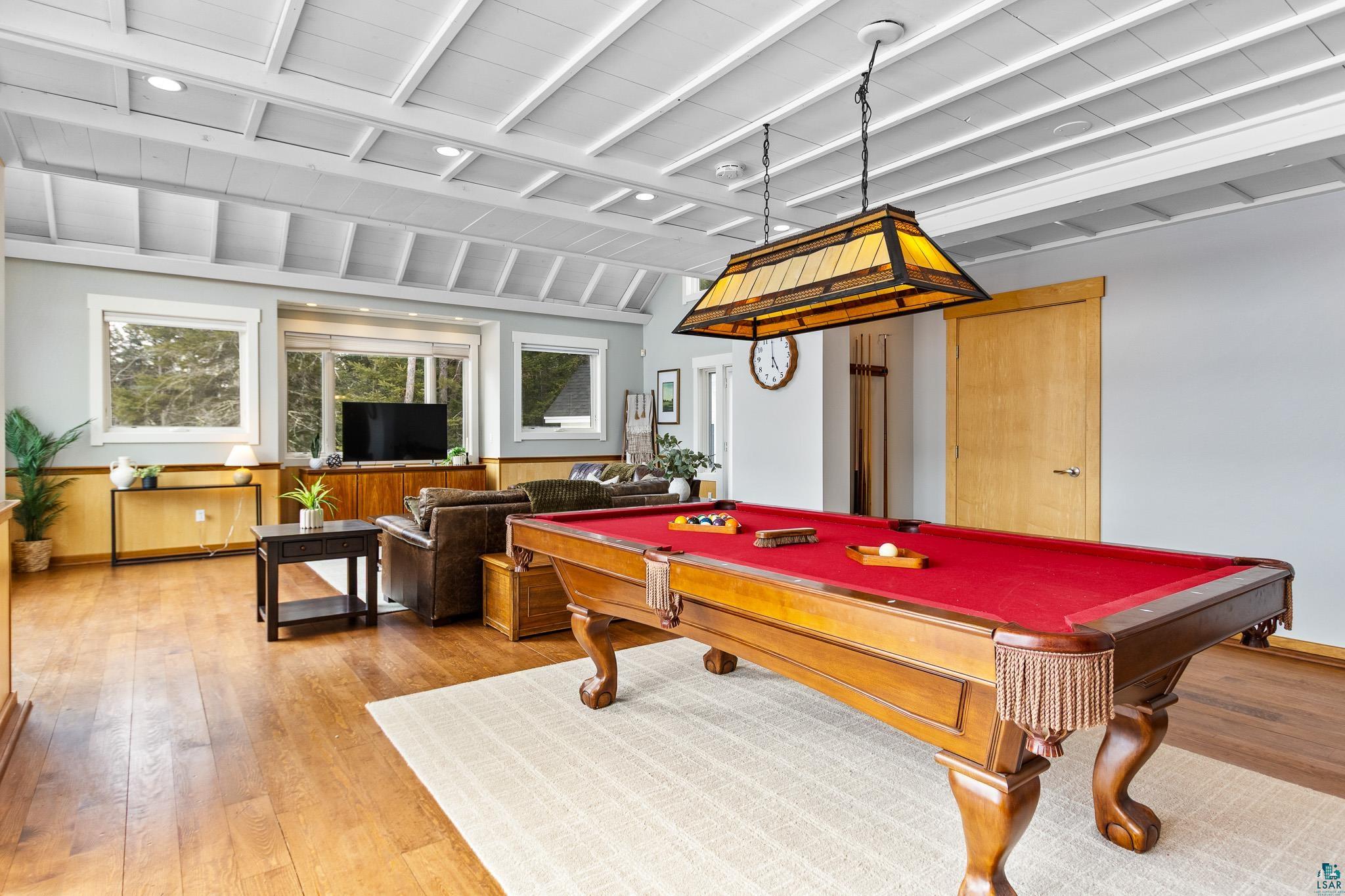 5163 Greenwood Road Duluth, MN 55804 - Photo 10 of 47 Spacious recreation area featuring a pool table with red felt, a Tiffany-style pendant light, and wood-finish flooring