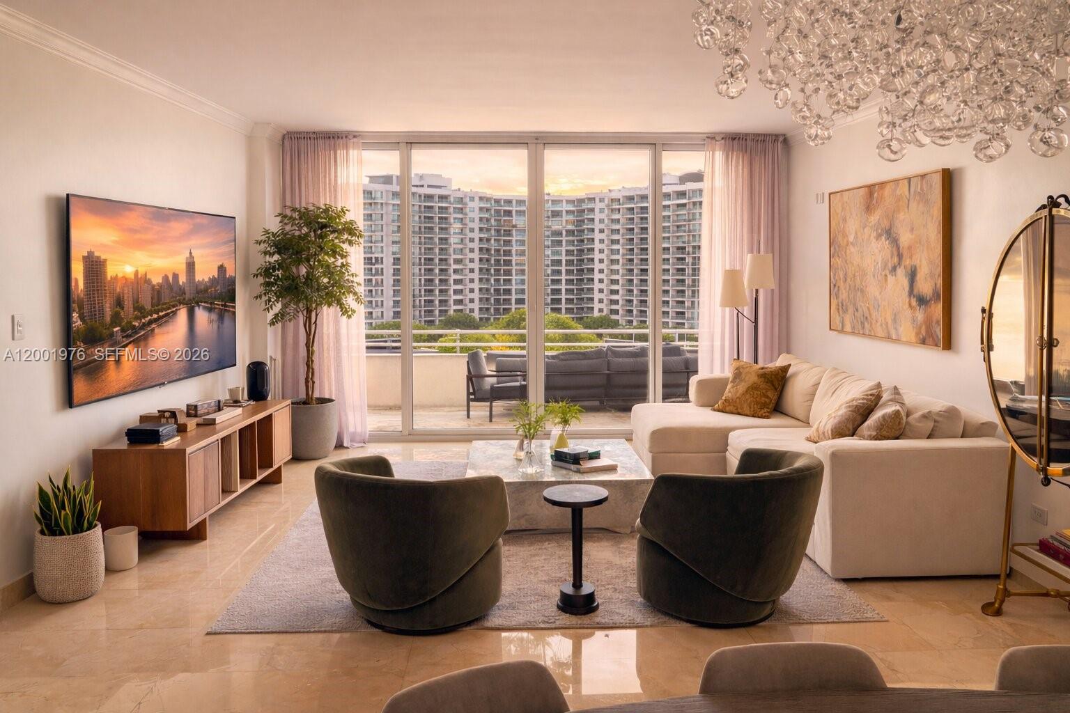 848 Brickell Key Drive, Unit 905 Miami, FL 33131 - Photo 1 of 28 a living room with furniture and a flat screen tv
