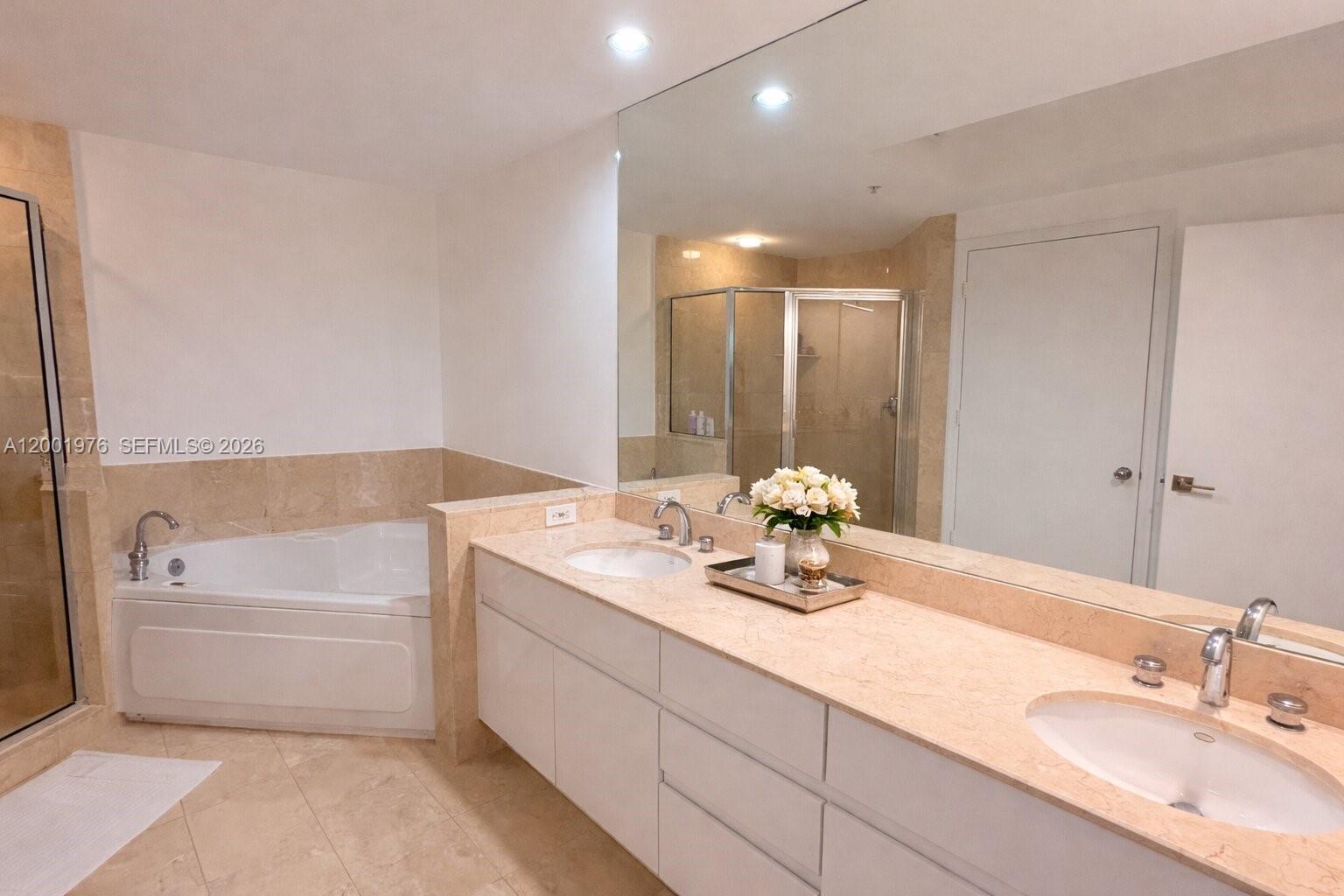 848 Brickell Key Drive, Unit 905 Miami, FL 33131 - Photo 11 of 28 a bathroom with a tub sink and mirror