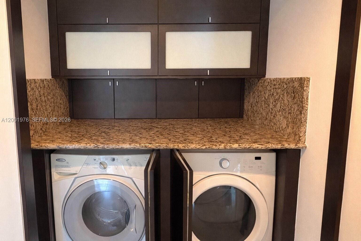 848 Brickell Key Drive, Unit 905 Miami, FL 33131 - Photo 13 of 28 a view of washer and dryer sitting next to a window
