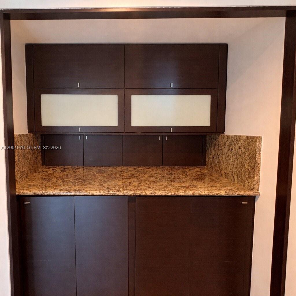 848 Brickell Key Drive, Unit 905 Miami, FL 33131 - Photo 14 of 28 a bathroom with a granite countertop sink and a mirror