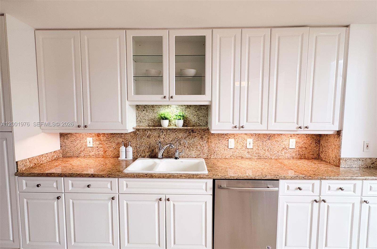 848 Brickell Key Drive, Unit 905 Miami, FL 33131 - Photo 15 of 28 a kitchen with granite countertop white cabinets and sink