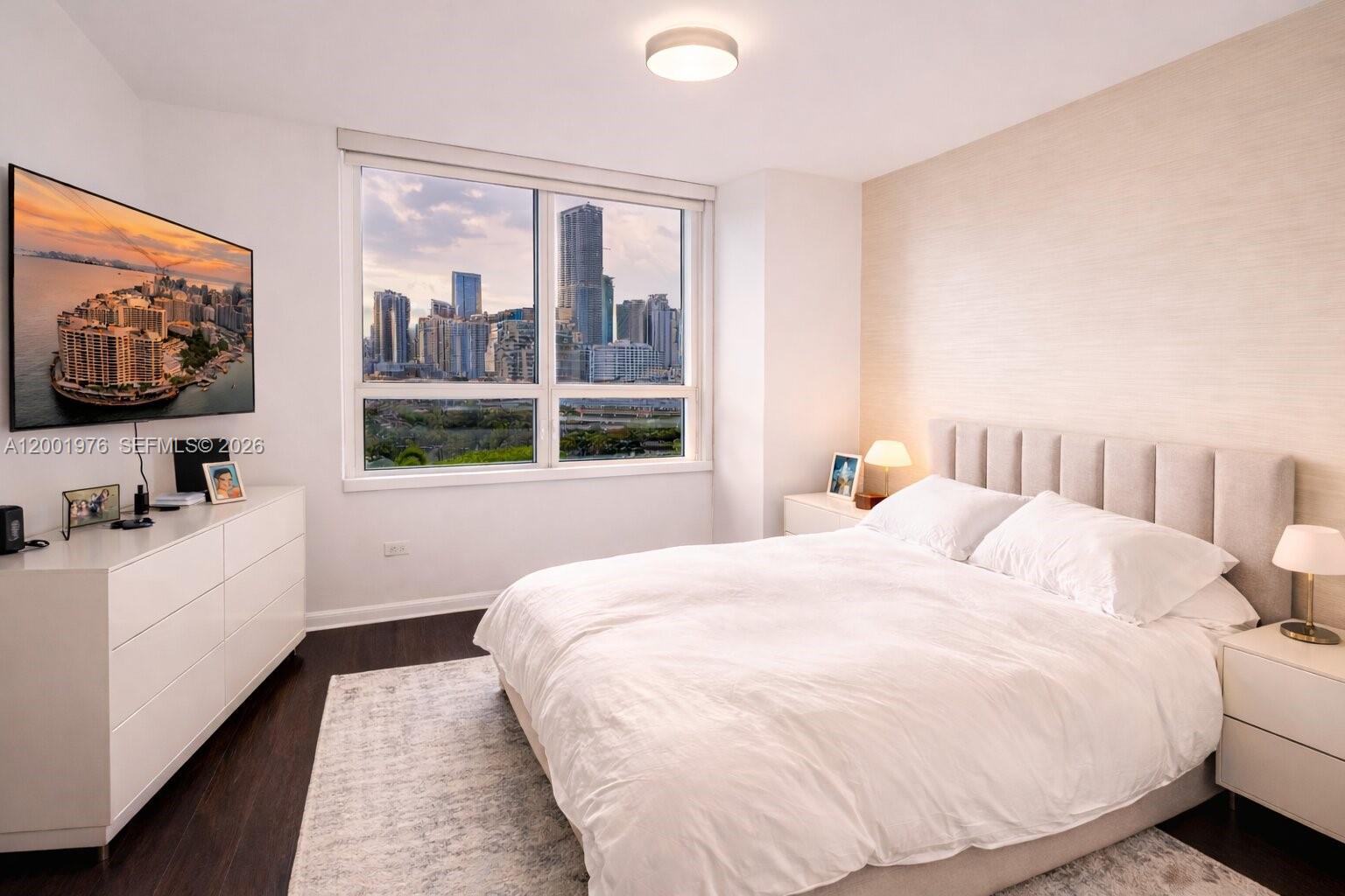 848 Brickell Key Drive, Unit 905 Miami, FL 33131 - Photo 18 of 28 a bedroom with a bed and a flat screen tv