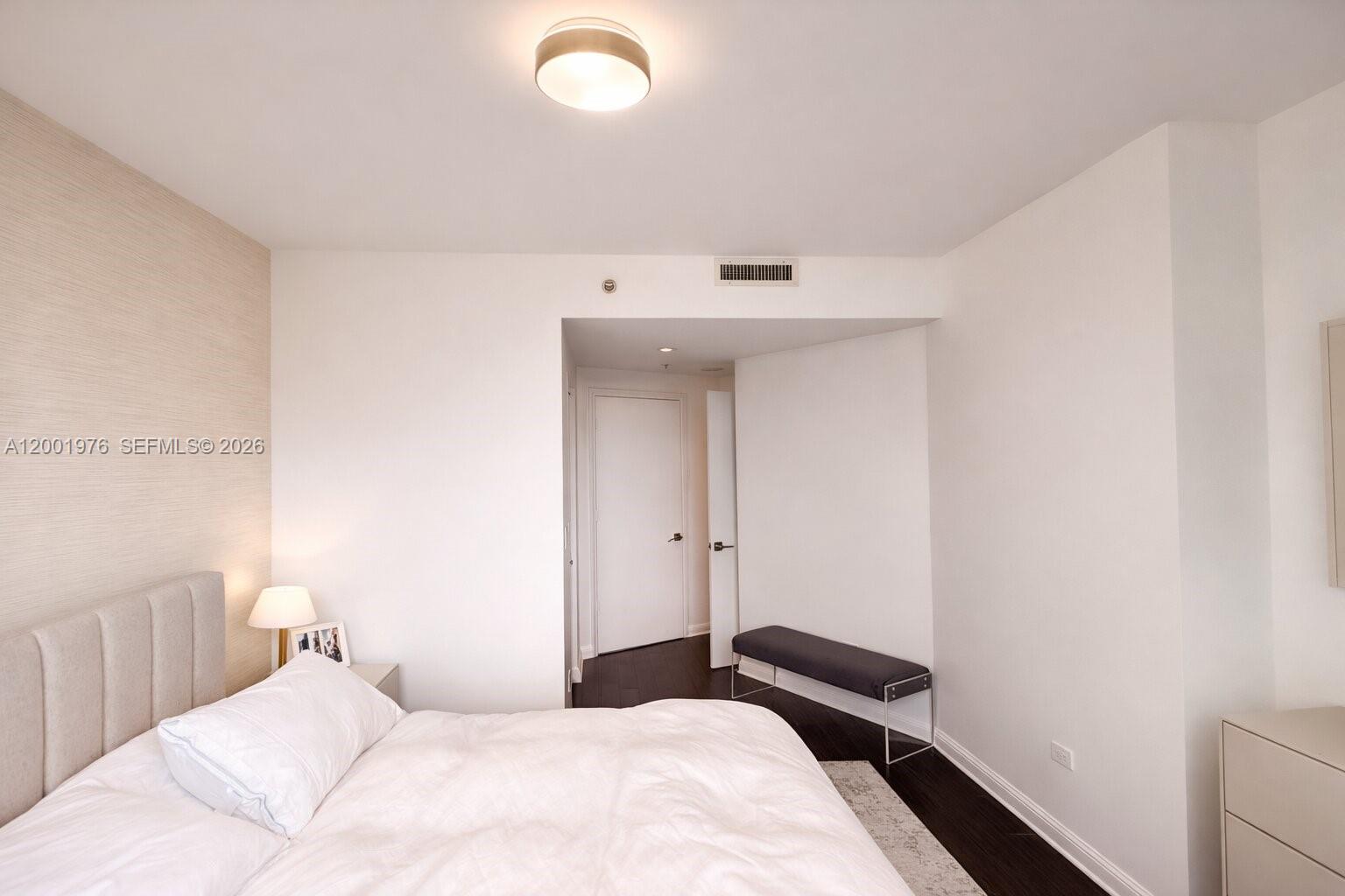848 Brickell Key Drive, Unit 905 Miami, FL 33131 - Photo 19 of 28 a bedroom with a bed and a window