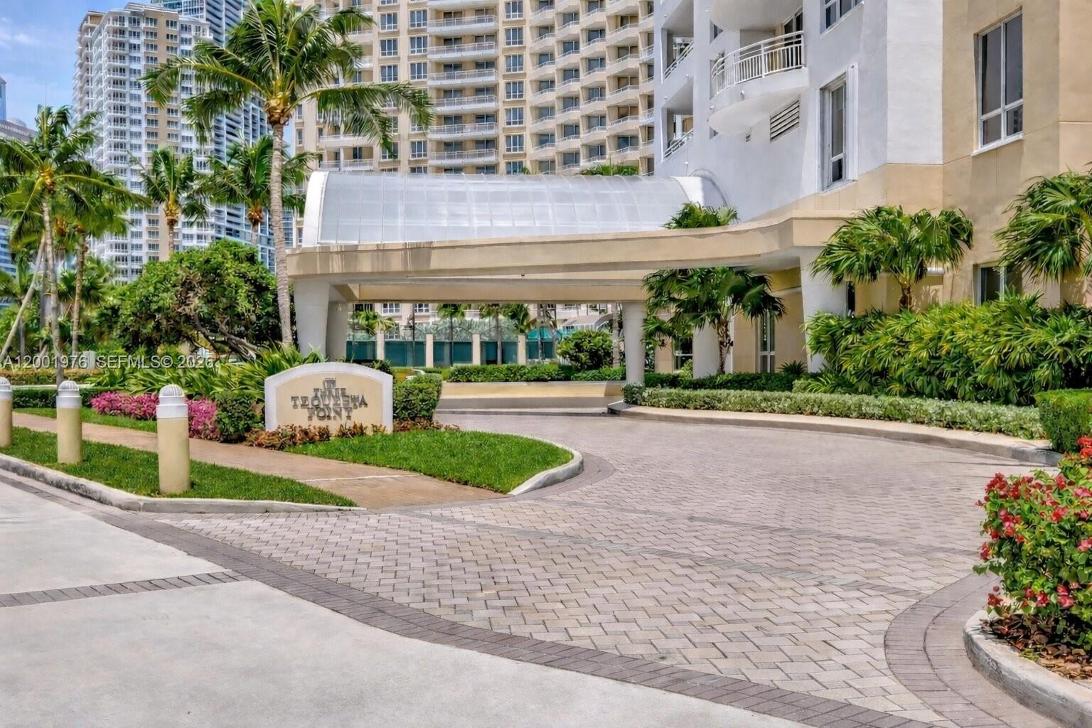 848 Brickell Key Drive, Unit 905 Miami, FL 33131 - Photo 27 of 28 a front view of a building with garden and plants