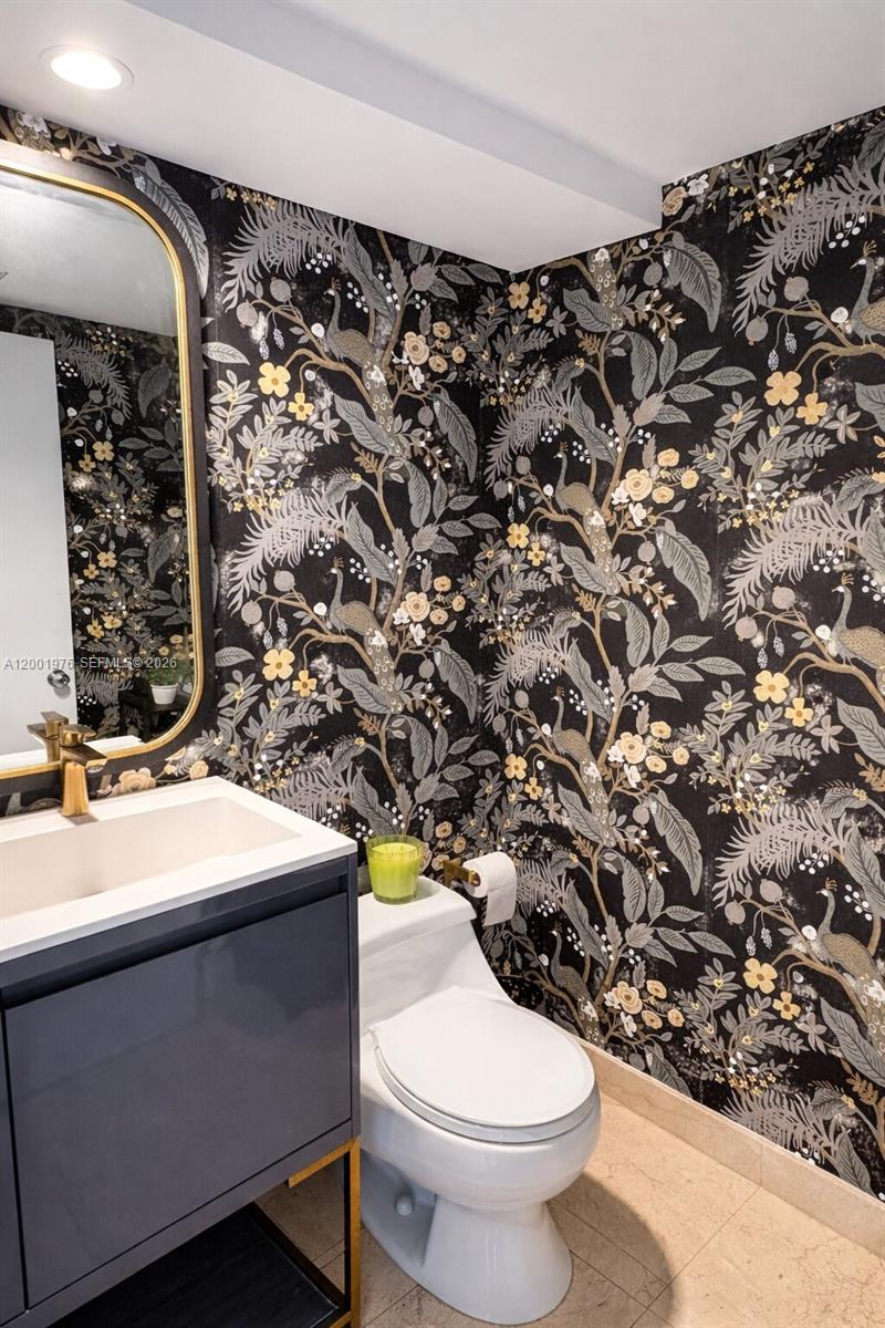 848 Brickell Key Drive, Unit 905 Miami, FL 33131 - Photo 7 of 28 a bathroom with a sink toilet and mirror
