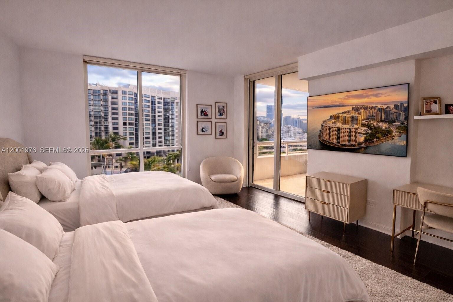 848 Brickell Key Drive, Unit 905 Miami, FL 33131 - Photo 8 of 28 a bedroom with furniture and a flat screen tv
