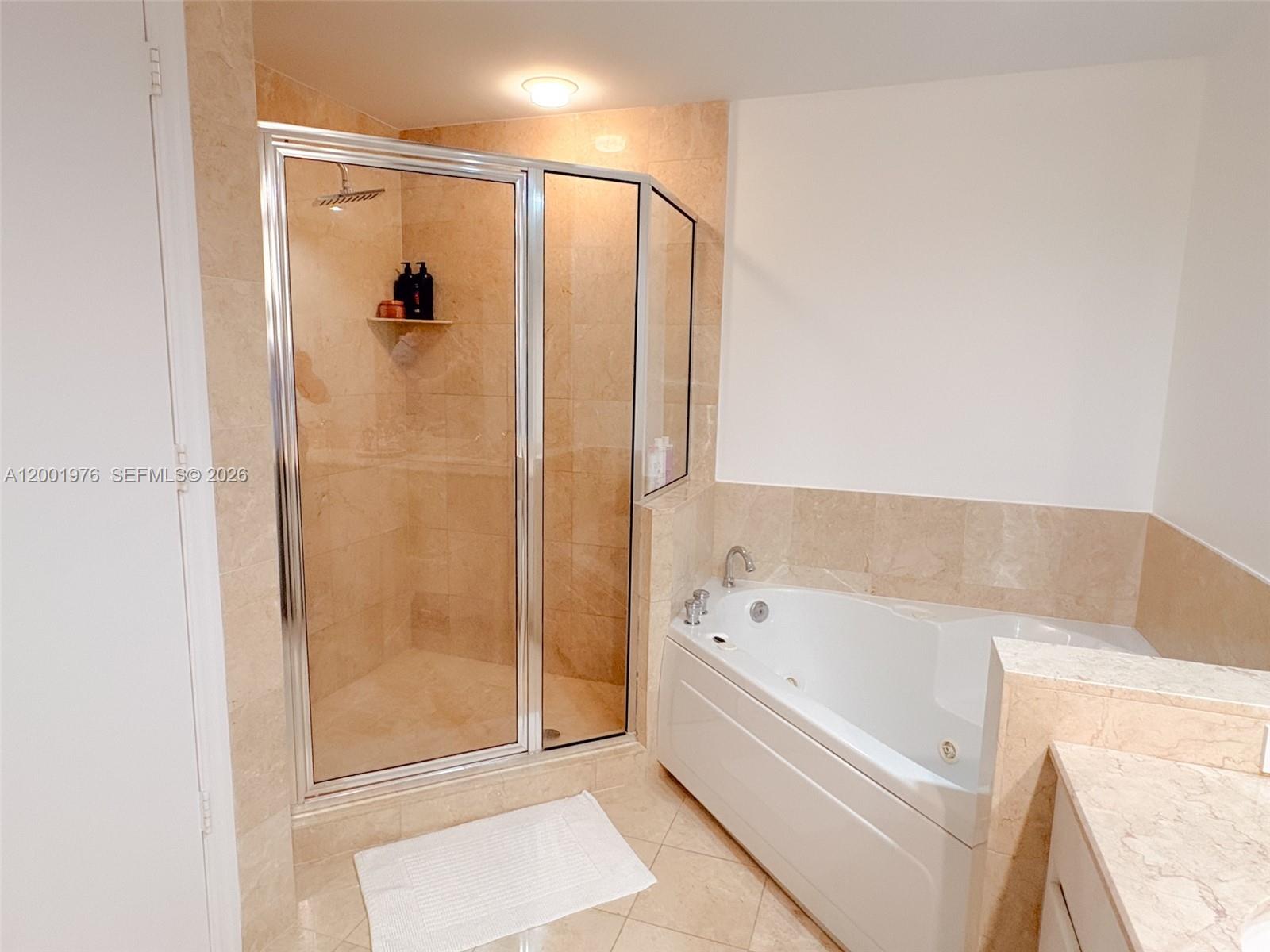 848 Brickell Key Drive, Unit 905 Miami, FL 33131 - Photo 10 of 28 a bathroom with a bathtub and a shower