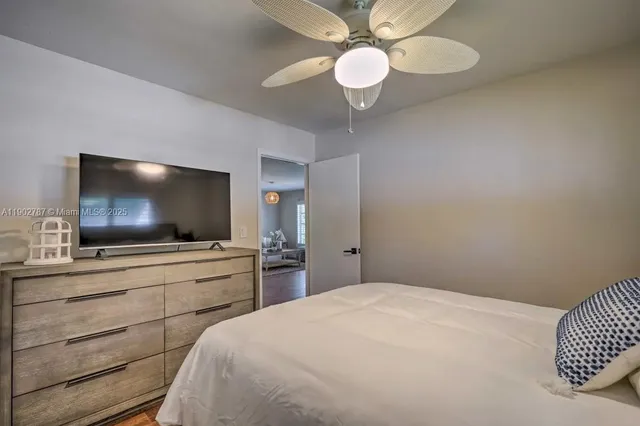 a bedroom with a bed and a flat screen tv