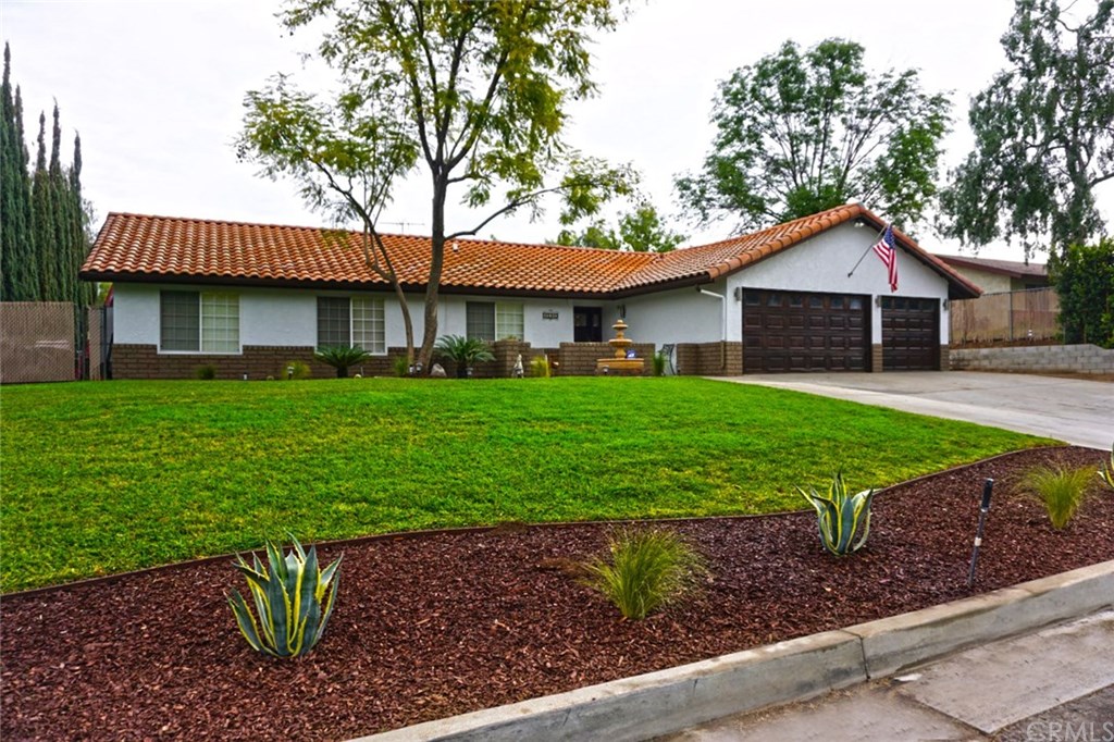 17010 Via Los Caballeros Riverside, CA 92504 - Photo 1 of 1 a front view of a house with a yard and potted plants