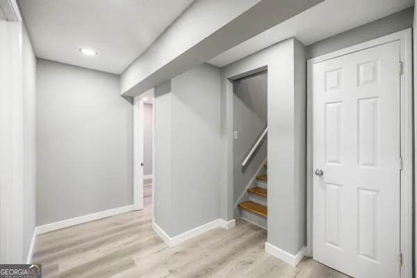 an empty room with windows and closet