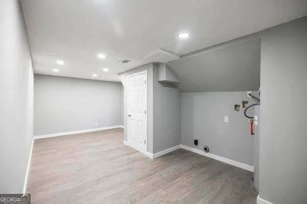 an empty room with windows and closet