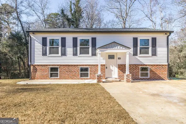 a front view of a house with a yard