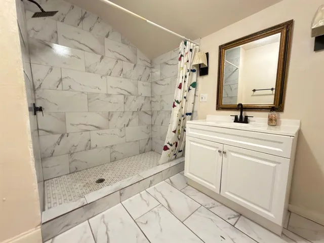 an empty room with wooden floor closet and windows