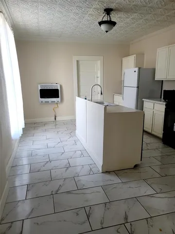 a living room with a couch and a stove top oven