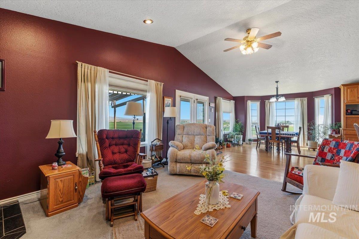 2331 Gulley Road Homedale, ID 83628 - Photo 8 of 46 Spacious living area featuring a vaulted ceiling with a ceiling fan, recessed lighting, and a blend of carpet and wood-finish flooring