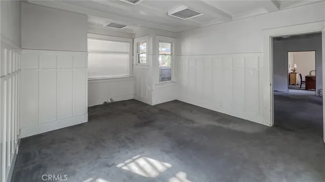 an empty room that has a grey walls