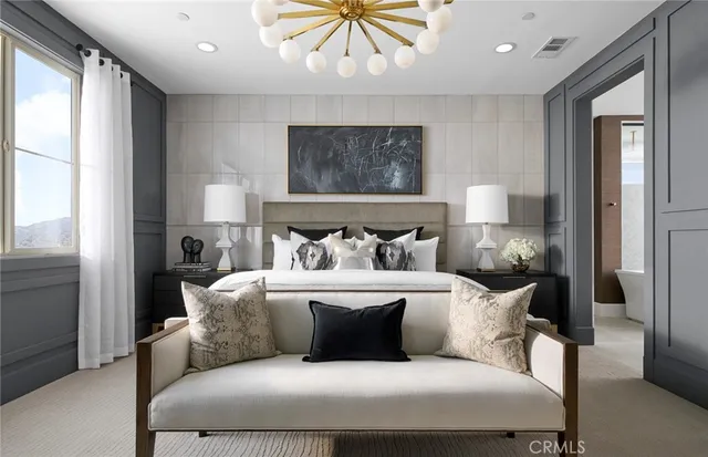 a large bedroom with a bed and a window