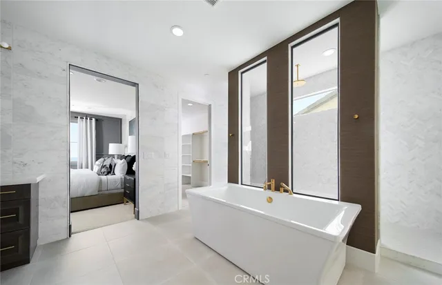a spacious bathroom with a tub and a large mirror