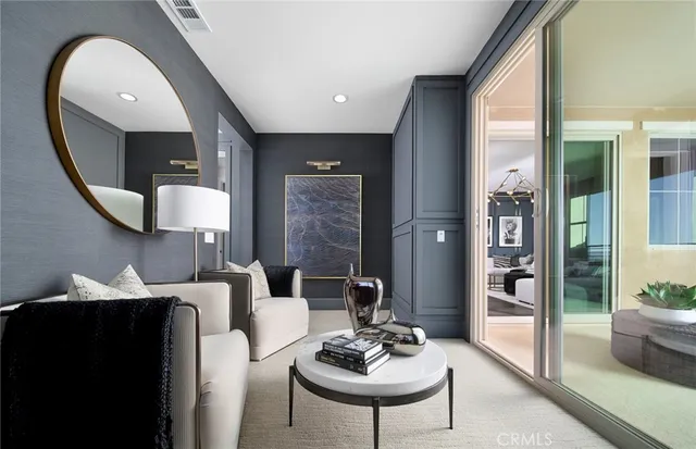 a living room with furniture and a mirror