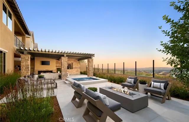 a view of a patio with couches table and chairs and potted plants