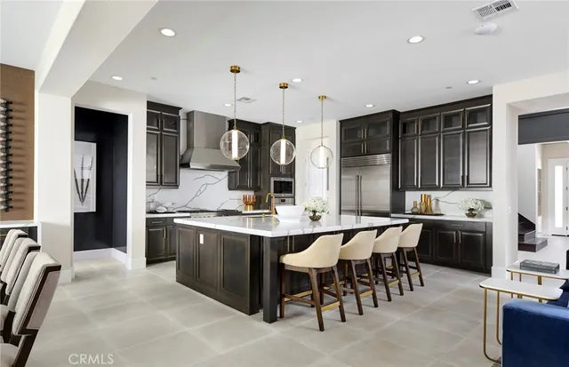 a kitchen with stainless steel appliances kitchen island granite countertop a sink and cabinets