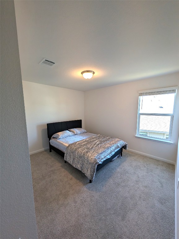 441 El Capitan Loop Dripping Springs, TX 78620 - Photo 13 of 26 a bedroom with a bed and window