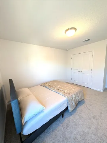 a bedroom with a bed and a table