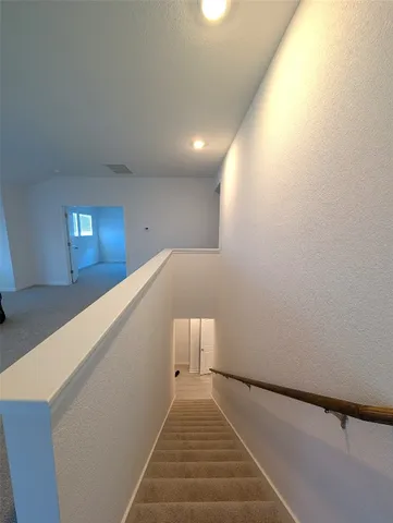 a view of an empty room with a window and fire place