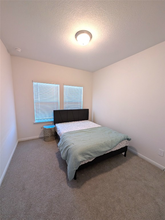441 El Capitan Loop Dripping Springs, TX 78620 - Photo 24 of 26 a bedroom with a bed and a window