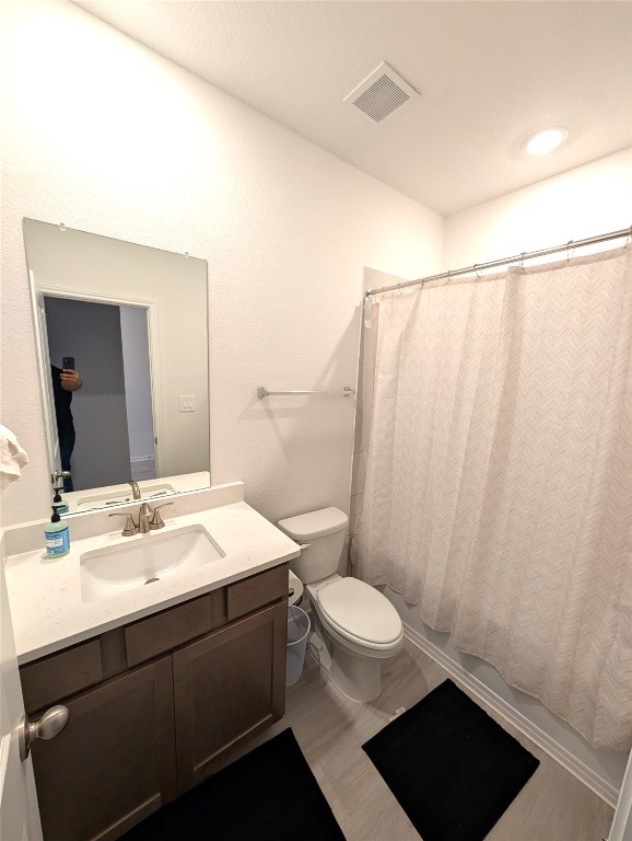 441 El Capitan Loop Dripping Springs, TX 78620 - Photo 26 of 26 a bathroom with a sink a toilet a mirror and shower