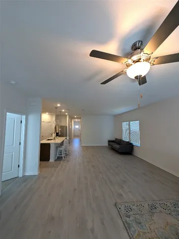 a view of a livingroom with fireplace and chandelier fan