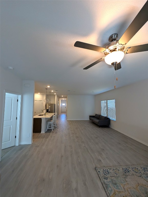 441 El Capitan Loop Dripping Springs, TX 78620 - Photo 6 of 26 a view of a livingroom with fireplace and chandelier fan