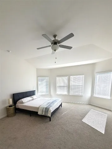 a bedroom with a bed and window