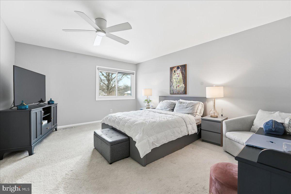 159 Henderson Place Hightstown, NJ 08520 - Photo 17 of 32 a spacious bedroom with a bed and a couch