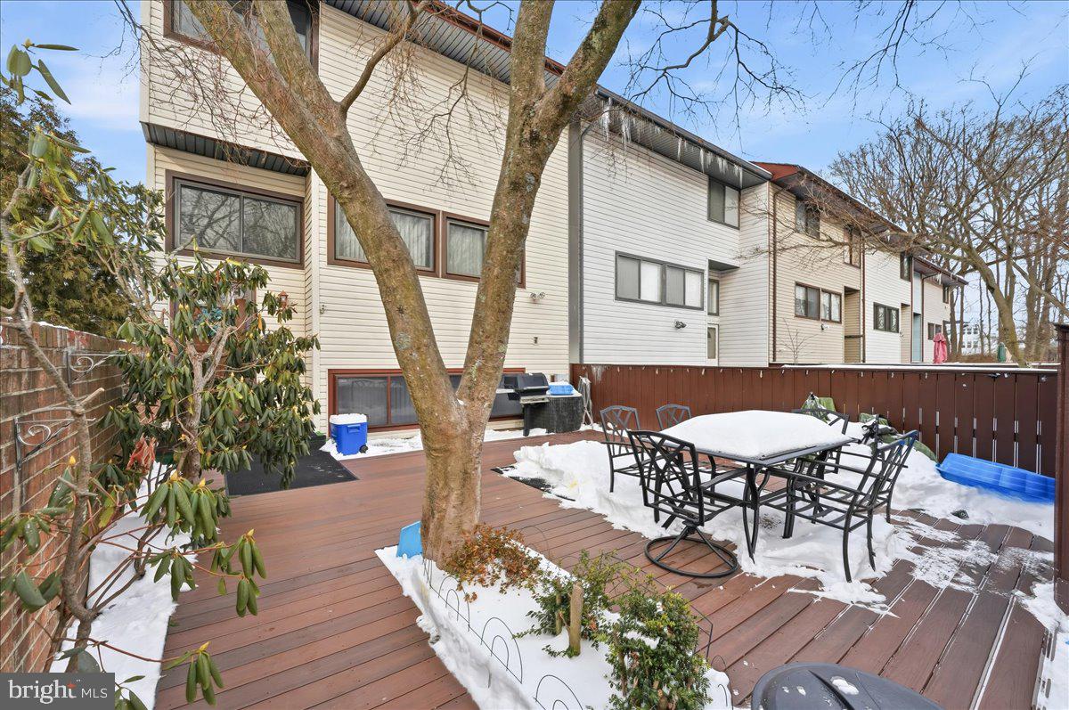 159 Henderson Place Hightstown, NJ 08520 - Photo 2 of 32 a view of a patio with table and chairs with wooden floor and fence