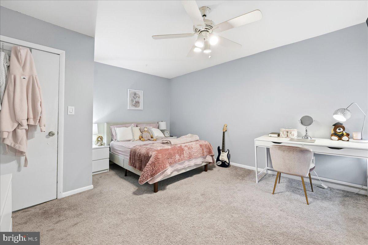 159 Henderson Place Hightstown, NJ 08520 - Photo 24 of 32 a spacious bedroom with a bed and a table