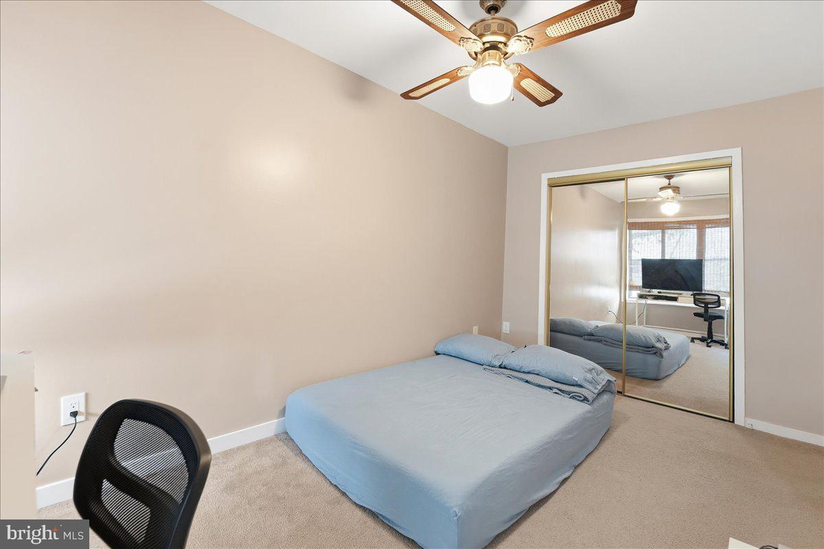 159 Henderson Place Hightstown, NJ 08520 - Photo 26 of 32 a bedroom with a bed and a chandelier