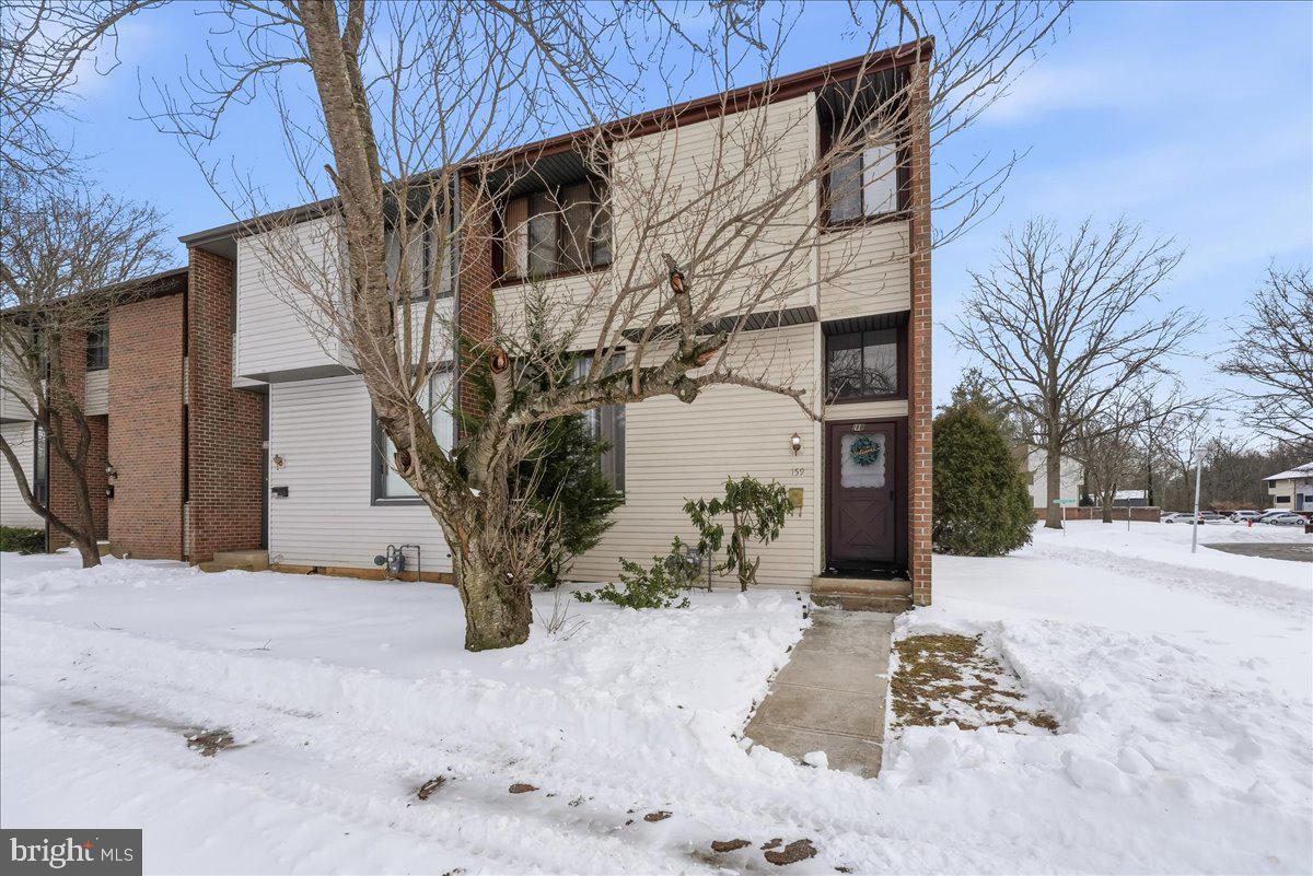 159 Henderson Place Hightstown, NJ 08520 - Photo 31 of 32 a view of a house with a yard covered in snow