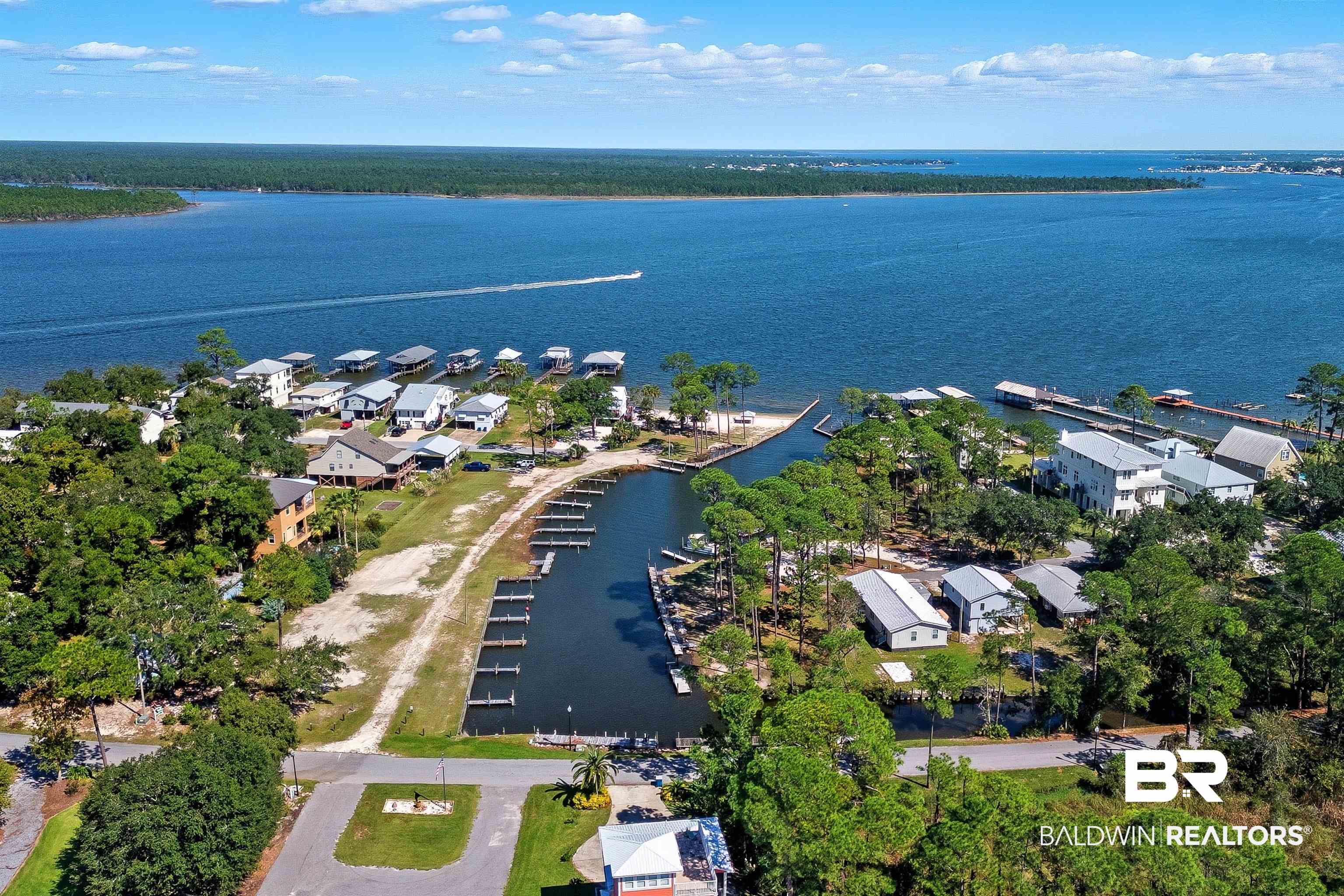 5310 Pine Road Orange Beach, AL 36561 - Photo 30 of 46 Aerial view of property and surrounding area with a nearby body of water and nearby suburban area