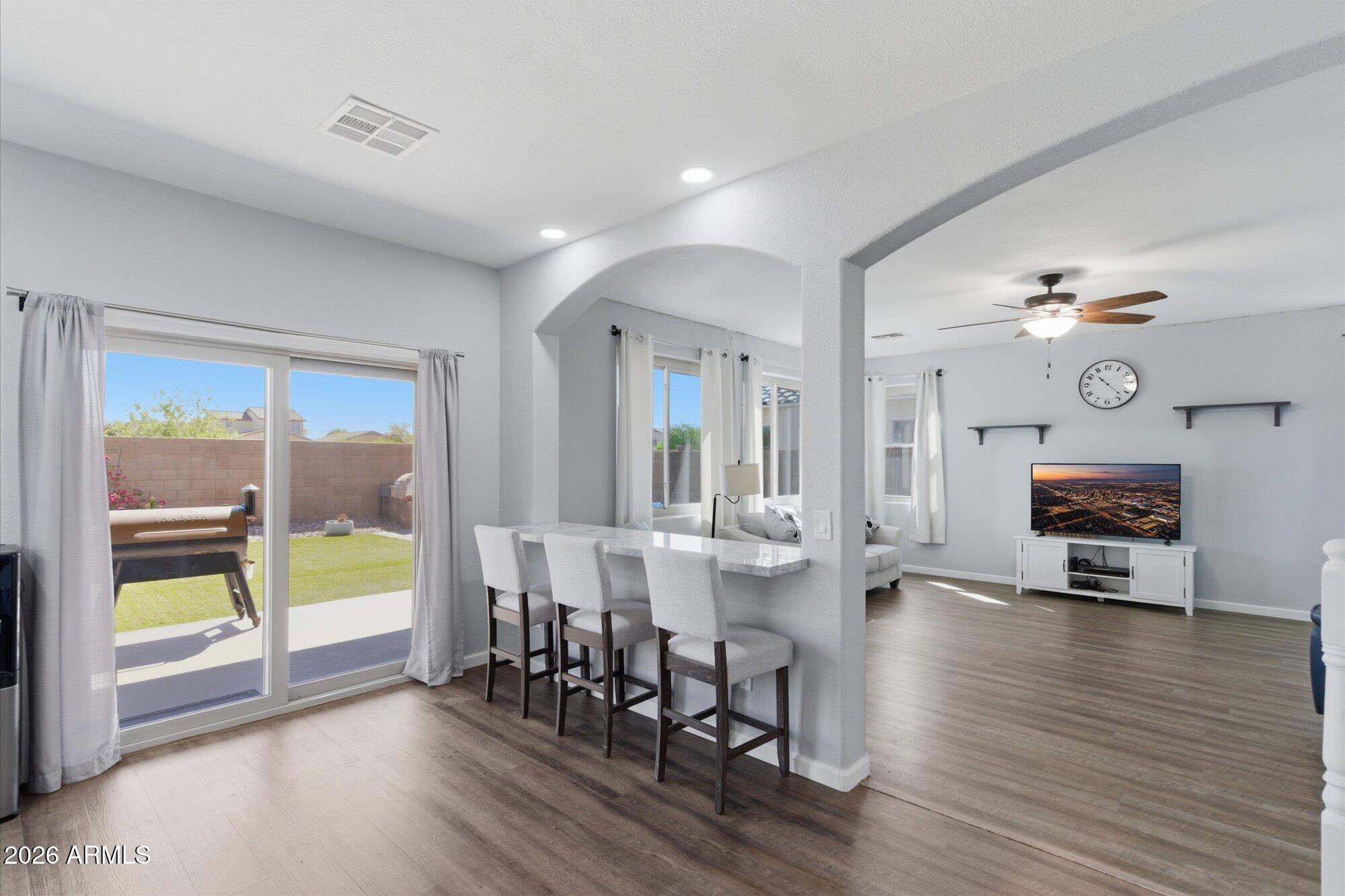21915 Dietz Drive Maricopa, AZ 85138 - Photo 7 of 31 a view of a dining room with furniture window and wooden floor