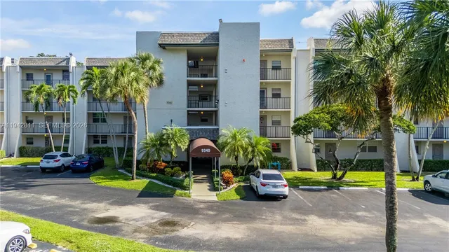 an aerial view of residential houses with outdoor space and swimming pool