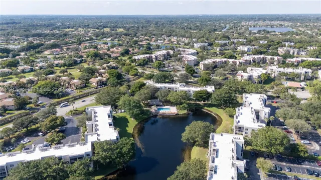 an aerial view of lake and residential houses with outdoor space