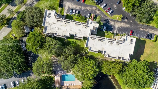 an aerial view of city lake and trees